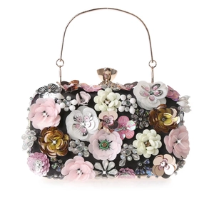 Close-up of 3D sequin floral patterns with pearls and gold metal handle on evening bag