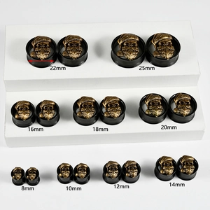 Black steel double flared ear gauges with bronze skull inlay in sizes 8mm to 25mm
