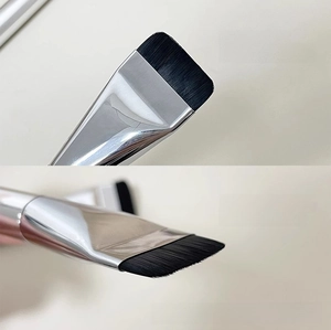 Macro shot of ultra-thin flat foundation brush with dense bristles for seamless application