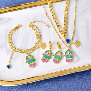 Golden Hamsa hand and Evil Eye jewelry set with layered necklace bracelet and earrings
