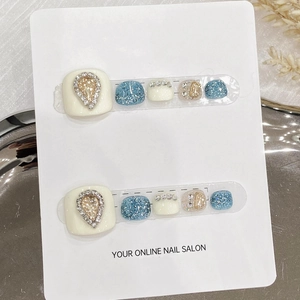 Handmade press-on toenails in cream white and blue glitter with water drop rhinestones