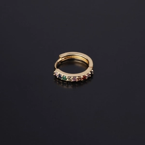Close-up of 18K gold huggie earring with rainbow cubic zirconia on black background