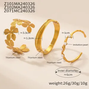Three 18K gold-plated titanium steel bangles with floral, striped and pearl details