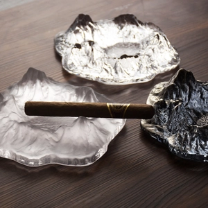 Glacier glass cigar ashtray with Mount Fuji mountain design on dark wood surface