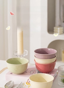 Detailed view of colorful glazed ceramic bowls in soft green pink and beige pastel tones