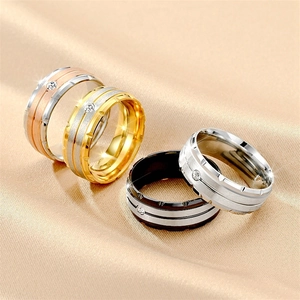 Detailed view of titanium steel rings with cubic zirconia inlay in various color finishes