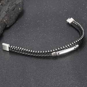 Detail of double-layer men's braided leather bracelet with silver steel beads