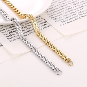 Detail of silver and gold Cuban link bracelets with rectangular links on white background