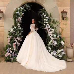 Elegant white satin wedding dress with sheer lace long sleeves and a long luxury train