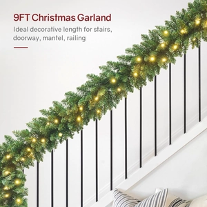 9ft Christmas garland with warm LED lights wrapped around a white staircase railing