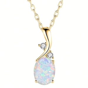 Close-up of golden oval opal pendant necklace with two sparkling cubic zirconia stones