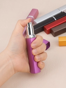 Close-up of portable 12ml square perfume spray bottle with textured aluminum shell
