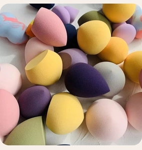 Flat lay of colorful teardrop and slanted sponge blenders in various pastel shades
