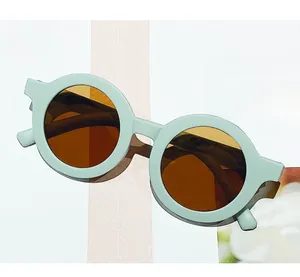 Detail of round mint green frames and amber lenses on kids vintage sunglasses