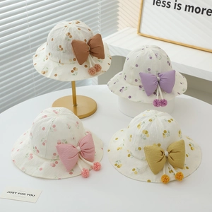 Baby sun hat with fruit print, large bow detail, and breathable eyelet texture