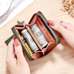 Green leather zipper wallet with tassel showing organized interior accordion compartments