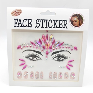 Pink face jewels and acrylic nail stickers on card for festival body makeup