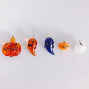 Detailed view of Halloween pumpkin and ghost pendants for DIY jewelry crafting