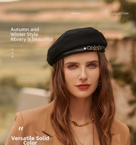 Detail of black beret with gold star studs and leather band in warm outdoor lighting