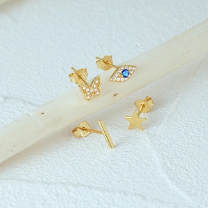 Detailed macro view of S925 sterling silver gold-plated stud earrings with zircon insets