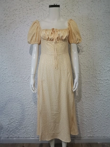 Detail of floral puff sleeves and front lace-up tie on a yellow summer maxi dress