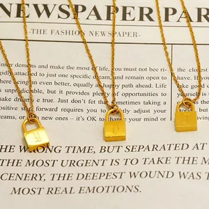 Minimalist gold lock pendant necklace set featuring engraved vintage letters Y D T
