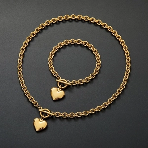 Golden stainless steel jewelry set with heart pendant necklace and toggle clasp bracelet
