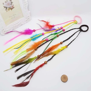 Close-up of bohemian children hair ring with colorful feathers and decorative plastic beads