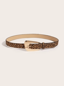 Detail shot of leopard print belt with irregular gold buckle on beige background