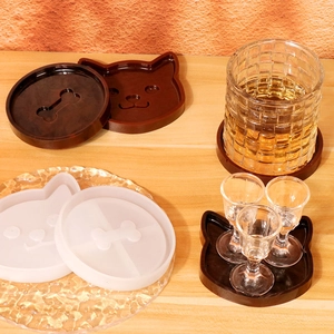Macro detail of cat and bone shaped silicone coaster molds with resin craft results