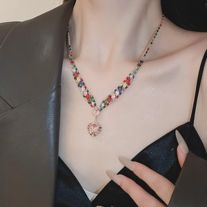 Close-up of a V-shaped necklace with a heart zircon pendant in rose gold on a model