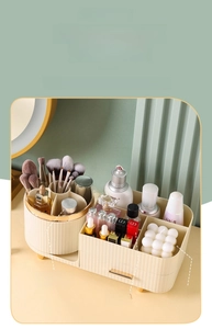 Close-up of cream cosmetic organizer with divided compartments and rotating brush holder