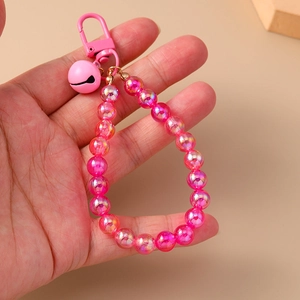 Detail of pink iridescent acrylic beads with matching bell and metal clasp attachment