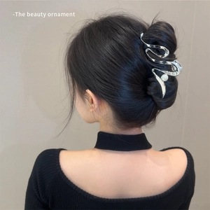 Elegant silver wavy metal hair claw clip with pearl accent shown on a model's hair