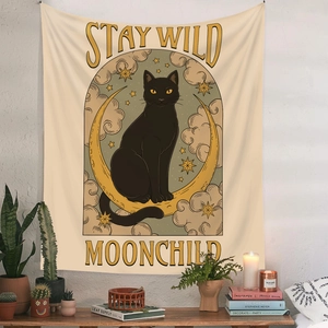 Detail of Bohemian tapestry featuring a black cat, moon, and Stay Wild Moonchild text