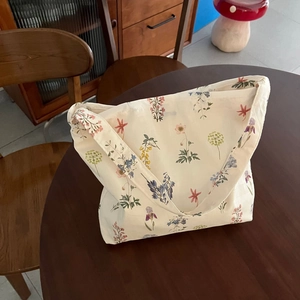 Floral print cotton tote bag with vintage botanical patterns on a beige shoulder bag