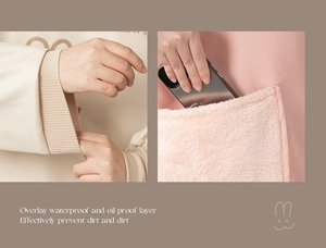 Detail of waterproof apron showing ribbed elastic cuffs and large plush pocket with bunny icon