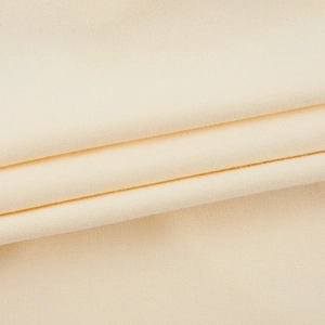 Close-up of soft beige fine knit fabric texture showing the premium material quality