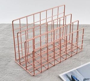Top view of rose gold metal file organizer with four slots for desk storage