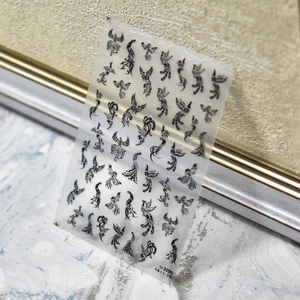 Detailed close-up of 5D embossed phoenix nail stickers with vintage Chinese style patterns