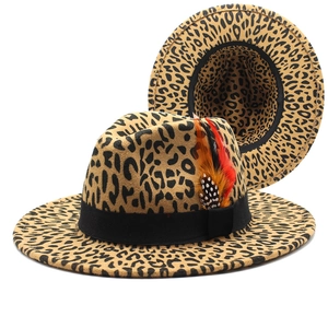 Detailed side view of leopard print fedora with elegant feathers and black ribbon band