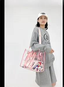 Detail shot of a clear PVC shoulder bag with pink webbing and internal organizer pouch
