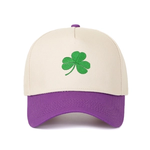 Detailed close-up of green clover embroidery on a color-block panel baseball cap