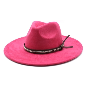 Détail d'un chapeau en feutre fuchsia avec bande en cuir marron et nœud latéral élégant