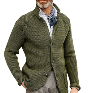 Detail of green knitted cardigan with stand collar and textured button-up front