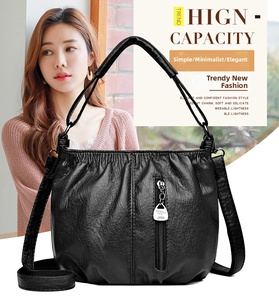 Detail of black pleated soft leather texture with metal kangaroo emblem and zipper detail
