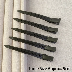 Set of five 9cm matte black metal hair clips with ventilation holes on fabric