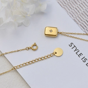 Gold rectangular drop necklace with starburst zircon stone in polished 18K gold plated steel
