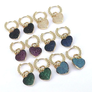 Detailed view of colorful heart-shaped zircon pendants on gold-plated earring hoops