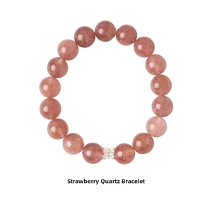 Detailed close-up of strawberry quartz beaded bracelet with a silver bow charm spacer